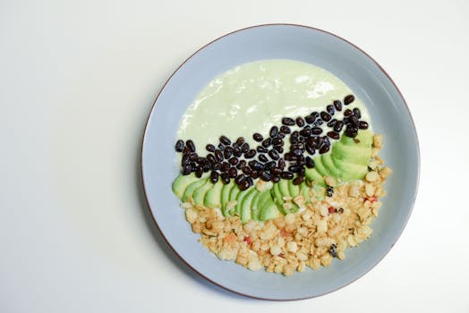 colorful breakfast bowl with avocado and dark chocolate